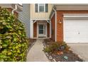 Inviting front entrance with brick accents, well-manicured bushes and clear house number signage at 295 Kigian Trl, Woodstock, GA 30188