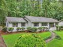 Lovely home with beautiful landscaping, including vibrant greenery, mulch beds, and a winding pathway at 2950 Duke Of Gloucester, Atlanta, GA 30344