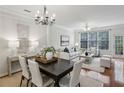 Bright open living and dining area featuring hardwood floors, modern decor, and large windows at 4662 Creekside Villas Se Way, Smyrna, GA 30082