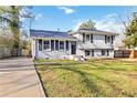Split-level home featuring updated white paint, dark shutters, and a freshly sealed driveway at 8331 Attica Ct, Jonesboro, GA 30238
