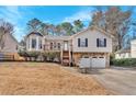 Exterior shot of a two-story home with a two-car garage and mature landscaping during the day at 1117 Mountain Springs Nw Dr, Kennesaw, GA 30144