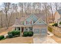 Beautiful two-story home featuring a stone facade, two-car garage, and professionally landscaped lawn at 170 Maple View Ct, Dallas, GA 30157