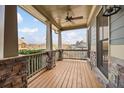 Cozy outdoor porch featuring stone accents, wooden flooring and views of the neighborhood at 170 Maple View Ct, Dallas, GA 30157