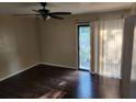 This bedroom features hard wood floors, a ceiling fan, and a sliding glass door to a balcony at 2722 Penwood Pl, Lithonia, GA 30058