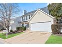 Street view of home featuring manicured landscaping, a driveway, and a two-car garage at 79 Greystone Way, Hiram, GA 30141