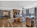 Open concept living room featuring a dining table, hardwood floors and rustic wood accent wall at 360 Chambers St # 301, Woodstock, GA 30188