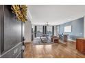 Open living room with hardwood floors, natural light, and stylish decor visible from the doorway. Number 301 is on the door at 360 Chambers St # 301, Woodstock, GA 30188