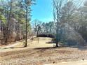 Wooded property featuring a long drive leading to a cozy brick home surrounded by nature and sunshine at 1091 Summer Lake Rd, Lithia Springs, GA 30122