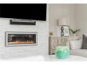 Close-up of modern fireplace with a large television above, with stylish decor at 16 Ramsey St, Roswell, GA 30075