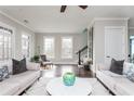 Open living room features hardwood floors, bright windows, and neutral paint at 16 Ramsey St, Roswell, GA 30075