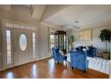 Bright foyer with hardwood floors, natural light, and a seating area at 4180 Mount Paran Dr, Social Circle, GA 30025