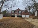 Traditional two-story brick home boasts an attached garage and a well-maintained front lawn at 4667 Derby Loop, Fairburn, GA 30213