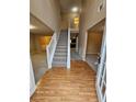Inviting foyer featuring wood floors transitioning to carpet, staircase, and soaring ceilings at 4667 Derby Loop, Fairburn, GA 30213
