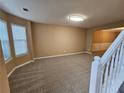 Bright living room with carpet flooring and large windows offering abundant natural light at 4667 Derby Loop, Fairburn, GA 30213