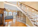 Spacious foyer with grand staircase, hardwood floors, and soaring ceilings providing an elegant entrance at 3428 Stembler Rdg, Douglasville, GA 30135