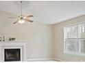 Bright living room features a ceiling fan, a fireplace, and ample natural light at 88 Linville Pte, Dallas, GA 30157