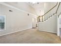 Spacious living room with large windows, a staircase, and bright neutral paint at 3641 Willow Club Dr, Loganville, GA 30052