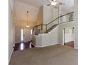 Spacious living room with soaring ceilings, staircase, and natural light at 3641 Willow Club Dr, Loganville, GA 30052