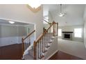 View of the stairs with wood banisters and carpeted steps looking into the living room and dining room at 3641 Willow Club Dr, Loganville, GA 30052