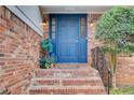Charming brick home with a vibrant blue front door and well-maintained landscaping at 2270 Old Concord Se Dr, Covington, GA 30016