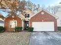 Charming home featuring a brick facade, manicured lawn, and inviting entryway at 396 Avian Forest Dr, Stockbridge, GA 30281