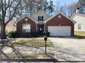 Well-maintained house featuring brick accents, attached two-car garage, and a well-kept front lawn at 396 Avian Forest Dr, Stockbridge, GA 30281