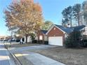 A suburban street view shows a row of houses, each with a garage and a neatly maintained lawn at 396 Avian Forest Dr, Stockbridge, GA 30281