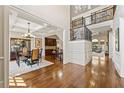 Elegant foyer showcases hardwood floors, coffered ceilings, iron stair railing, and views to the living area at 9070 Waits Ferry Xing, Johns Creek, GA 30097