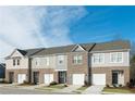 New townhomes showcase a blend of brick and siding, complete with attached garages and inviting entrances at 3015 Acacia Cir, Douglasville, GA 30135