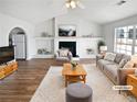 Cozy living room featuring a fireplace, vaulted ceilings, and a large window with natural light at 6782 Gina Agha Cir, Lithonia, GA 30038