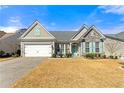 Inviting one-story home with a well-manicured lawn, a two-car garage and attractive stone accents at 912 Santa Anita Dr, Woodstock, GA 30189