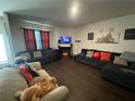 Living room featuring laminate floors, a fireplace and multiple sofas for seating at 1720 Danville Dr, Mcdonough, GA 30253