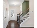 Bright hallway with hardwood floors and staircase leading upstairs at 2066 Charcoal Ives Rd, Lawrenceville, GA 30045