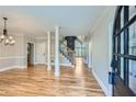 Welcoming entryway with hardwood floors, decorative columns, staircase, and natural light at 3330 Valley Vista Se Rd, Smyrna, GA 30080