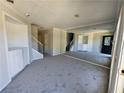 Spacious carpeted living room featuring staircase, with a large mirror wall adding depth at 400 Prince Of Wales, Stone Mountain, GA 30083