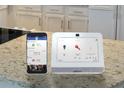 Smart home system on marble countertop to manage security, climate, and more at 1818 Lacebark Elm Way, Lawrenceville, GA 30045