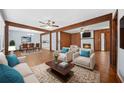 Cozy living room with wood paneling, a fireplace, and neutral furnishings at 2649 Lake Harbin Rd, Morrow, GA 30260