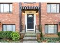Close-up of the front entrance with striped awning, lighting, and black door at 323 3Rd Ne St # 5, Atlanta, GA 30308