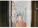 Welcoming hallway with hardwood floors leads to the kitchen and living areas of this modern condo at 1080 Peachtree Ne St # 2006, Atlanta, GA 30309