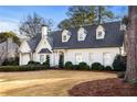 Charming two-story white brick home with manicured front yard and mature trees at 3063 Peachtree Ne Dr, Atlanta, GA 30305