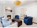 Open-concept living room with a fireplace, modern furnishings, and bright lighting at 3063 Peachtree Ne Dr, Atlanta, GA 30305