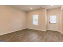 The living room features ample natural light, durable wood flooring, and neutral wall colors at 412 Barley Lot 86 Ct, Covington, GA 30014