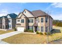 Beautiful brick home with a well-maintained lawn and an attached two-car garage at 310 Nw Brightfield Dr, Loganville, GA 30052