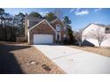 Attractive brick home with a two-car garage and a long driveway at 849 Kirsten Jane Ct, Lawrenceville, GA 30045