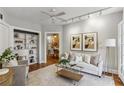 Bright living room with hardwood floors, modern track lighting and stylish furniture at 272 14Th Ne St # 18, Atlanta, GA 30309