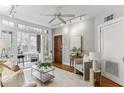 Cozy living room leading to sunroom with ample natural light and hardwood flooring at 272 14Th Ne St # 18, Atlanta, GA 30309