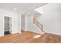 Bright entryway featuring hardwood floors and staircase with contemporary railings at 3474 Dryden Se Ln, Vinings, GA 30339