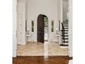 Inviting foyer with marble floors, arched doorway, and staircase with iron railing at 675 W Paces Ferry Nw Rd, Atlanta, GA 30327