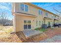 An expansive backyard area featuring sliding glass doors and a small patio for each unit at 6884 Robinson St, Lithonia, GA 30058