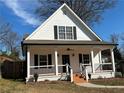 Beautiful white home with black shutters and a cozy front porch at 180 S Alexander St, Buford, GA 30518
